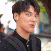 a close up of a young man wearing ear buds .
