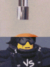 a pixelated image of a lego character with the letter ns on his vest