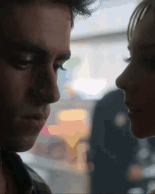 a close up of a man and a woman 's faces