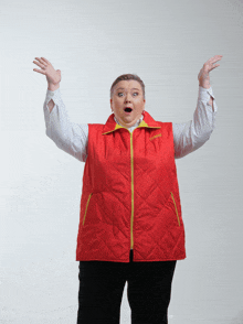 a woman wearing a red vest with the word columbia on the front