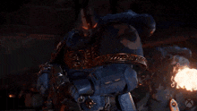 a video game character is firing a flamethrower in the dark