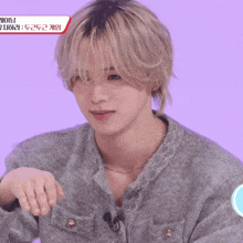 a close up of a person 's face with a purple background and korean writing on it