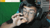 a man wearing glasses and headphones is playing a game