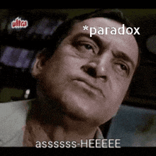 a man is making a funny face with the words `` paradox '' written above him .