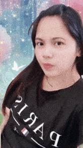 a woman wearing a black shirt that says pisaq on it