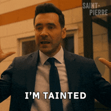 a man in a suit says i 'm tainted