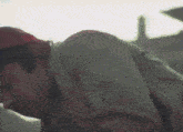 a close up of a person 's face with a red hat on their head