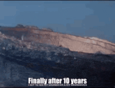 a picture of a mountain with the words finally after 10 years