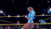 a female wrestler in a ring with the letters sn on the bottom left