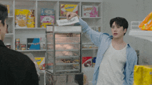 a man in a store holds up a sign that says ' happy ' on it