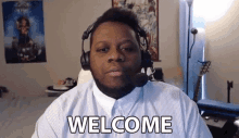 a man wearing headphones and a microphone says welcome