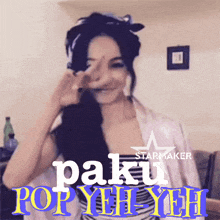 a woman making a peace sign in front of a sign that says paku pop yeh yeh