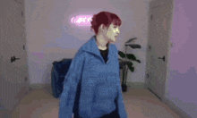 a person in a blue jacket is standing in front of a pink sign