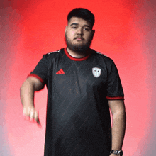 a man with a beard wearing an adidas shirt