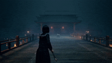a woman holding a sword stands on a bridge in front of a temple