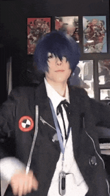 a person in a cosplay costume is standing in front of a wall with posters .