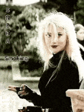 a woman with blonde hair is smoking a cigarette while wearing a black shirt .
