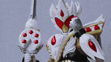 a toy with a sword and shield is against a wall