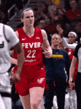 a female basketball player in a red jersey with the number 22 on it