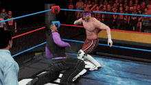 a wrestler with a bandana on his head is fighting another wrestler in a wrestling ring