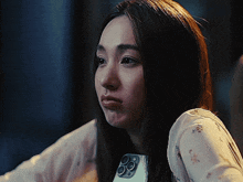 a woman is holding a phone in her hand and making a face