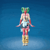 a girl with a red face and green hair is dancing with her hands in the air