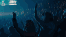 a blurry picture of a person holding a guitar in a dark room