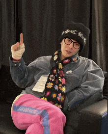 a person wearing glasses and a hat that says chrome hearts