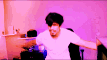 a man in a white shirt is standing in front of a purple wall