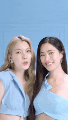 a couple of women standing next to each other and smiling