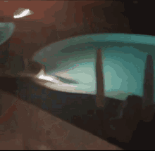a blurred image of a swimming pool at night with a light shining on it