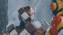 two robots are standing next to each other and one of them is wearing a helmet with the letter l on it .