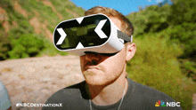 a man wearing a virtual reality headset with the letters x and x on it