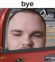 a man is looking out of a car window with the words bye above him