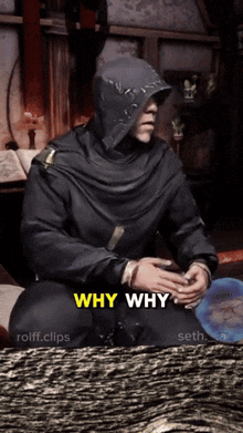a man in a hooded cloak is asking why