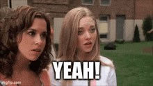 two women are standing next to each other and one of them is saying `` yeah '' .