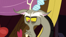 a close up of a cartoon character with a yellow eye and the letter g on his face
