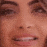 a close up of a woman 's face wearing a headset and smiling