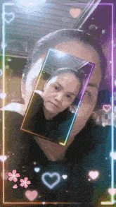 a woman is taking a picture of herself in a rainbow frame