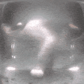 a blurred image of a person 's face with a light coming out of it