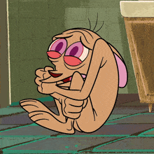 a cartoon character is sitting on the floor with his arms crossed