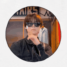 a man wearing sunglasses and a denim jacket is in a circle with the word airs on it