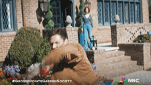 an advertisement for grosse pointe garden society shows a man throwing flowers