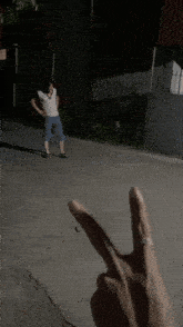 a person 's finger is pointing at a man 's chest