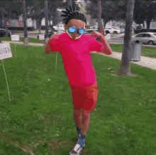 a person in a pink shirt is running in a park