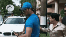 a man wearing a blue shirt with the number 5 on the back