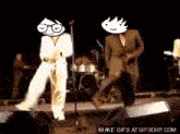 two men in suits are dancing on a stage in front of a microphone and a drum set .