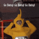 a woman in a yellow teletubbies costume says go daisy go daisy go daisy