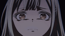 a close up of a girl 's face with a very sad look on her face