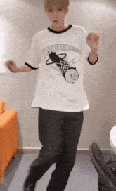 a man wearing a white thunder t-shirt is dancing